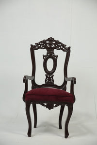 Dark brown carved wooden arm chair with maroon poshish. - GS Productions