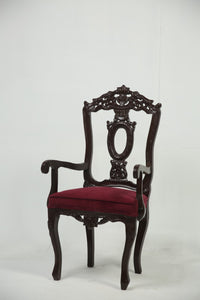 Dark brown carved wooden arm chair with maroon poshish. - GS Productions