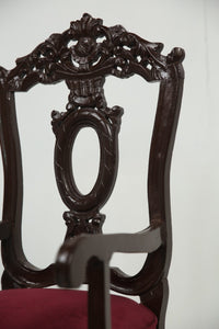 Dark brown carved wooden arm chair with maroon poshish. - GS Productions